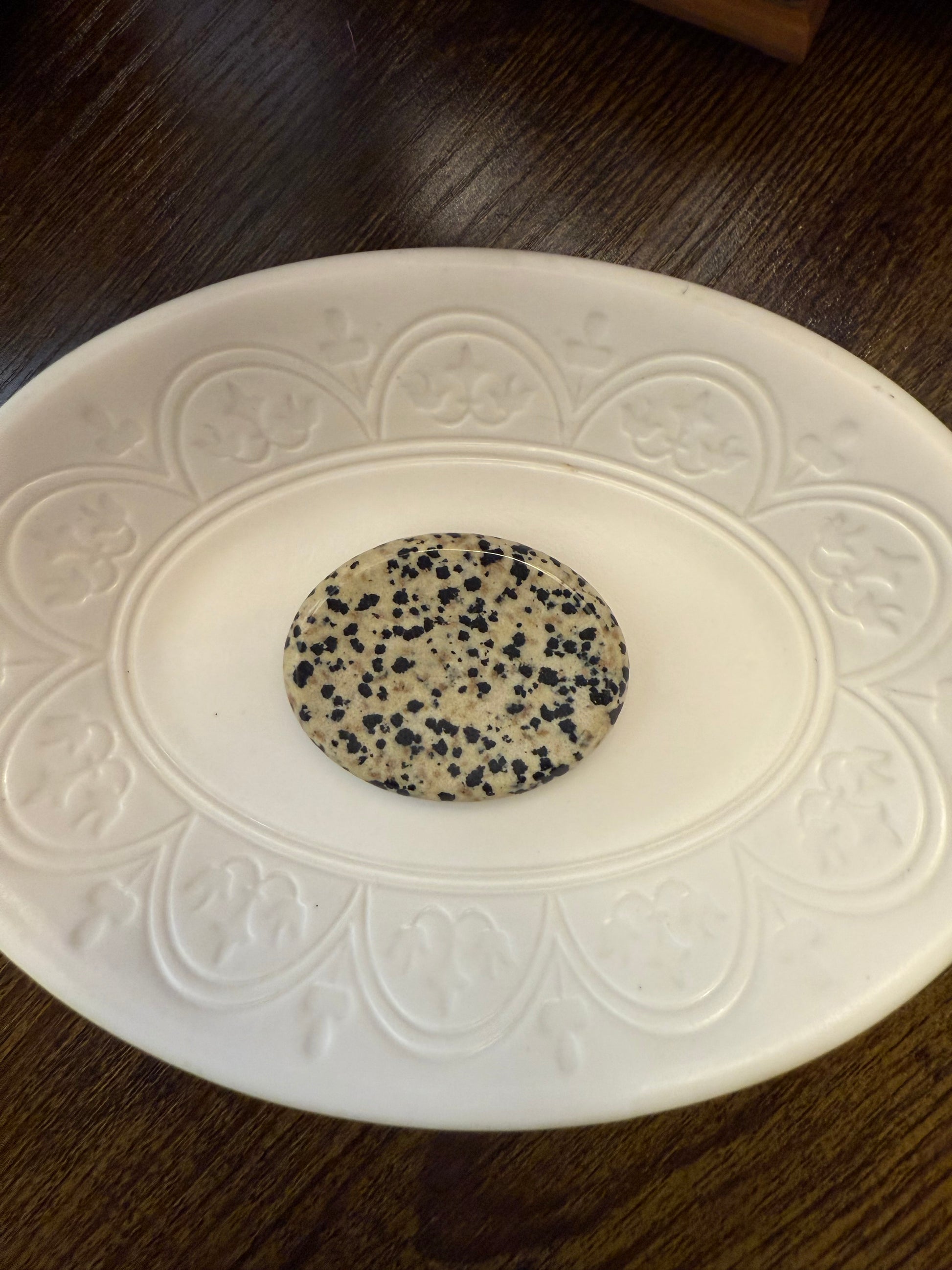 Dalmatian Jasper Worry Calming Stone on a decorative white plate