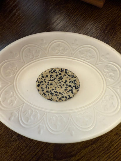 Dalmatian Jasper Worry Calming Stone on a decorative white plate