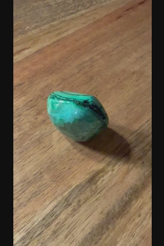 Malachite tumbled crystal stone video showing natural green color and texture